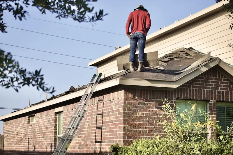 Professional roofer working on a residential roof in Hitchcock